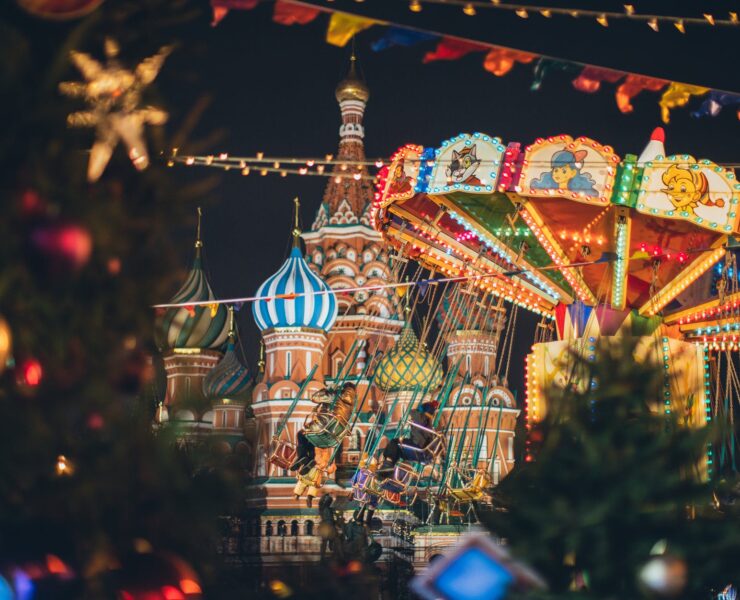 colorful carousel against cathedral on red square at new year night