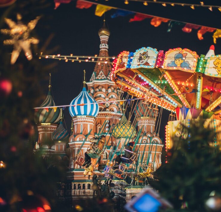 colorful carousel against cathedral on red square at new year night