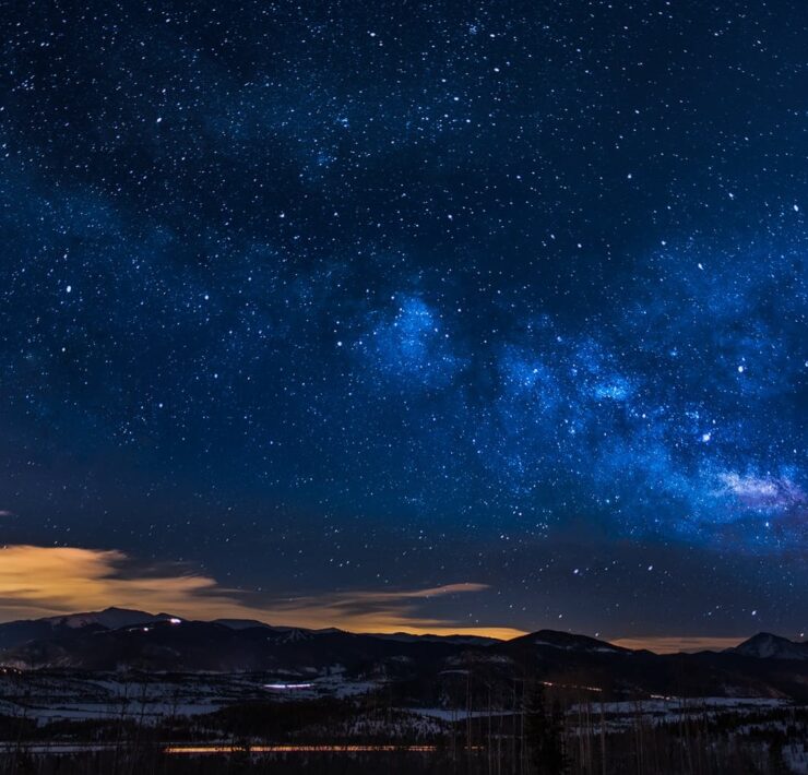 black mountains under the stars at nighttime