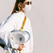 woman in mask holding toilet paper