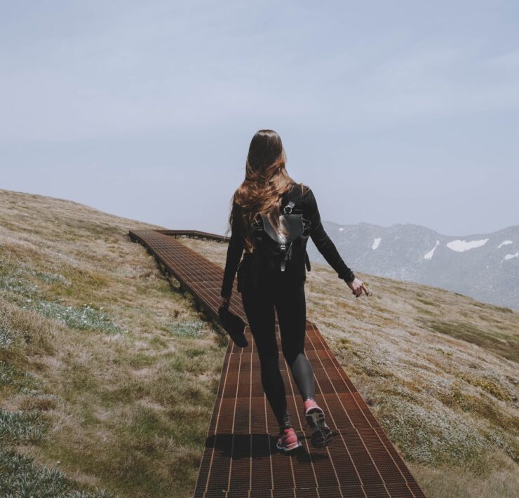 a woman hiking on a mountain