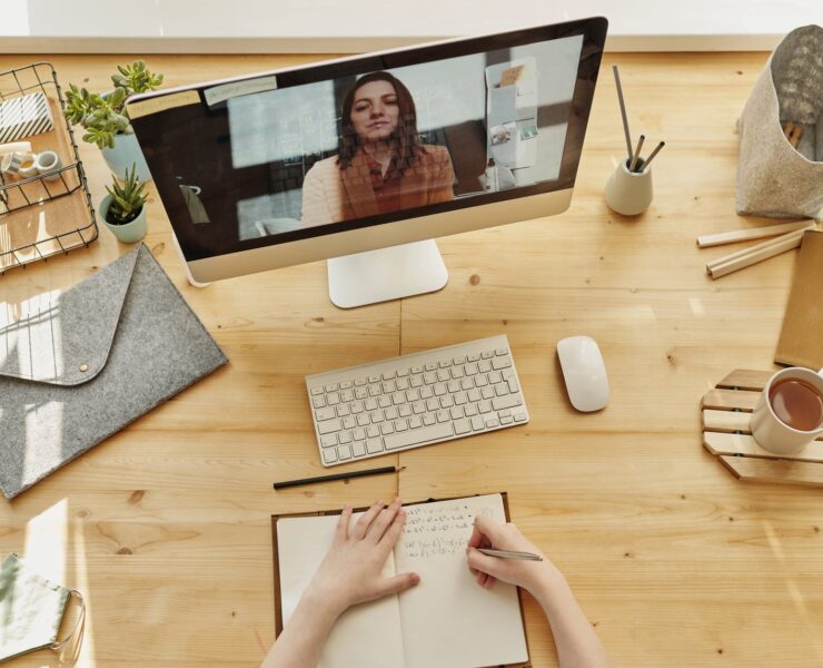 person writing on notebook
