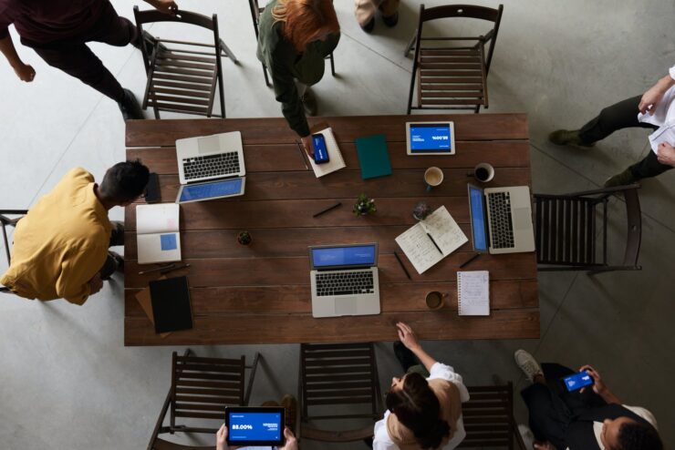 photo of laptops on top of wooden table