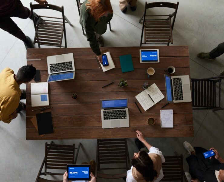 photo of laptops on top of wooden table