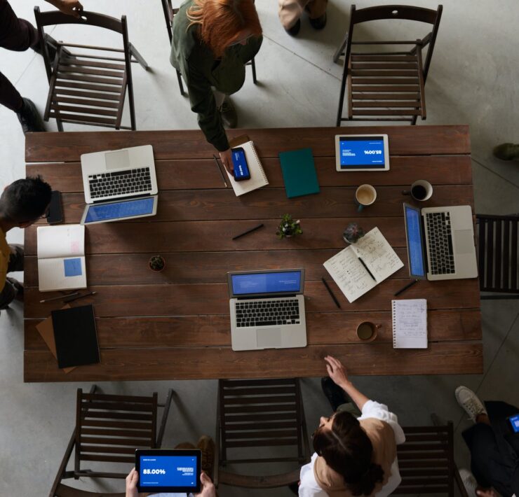 photo of laptops on top of wooden table