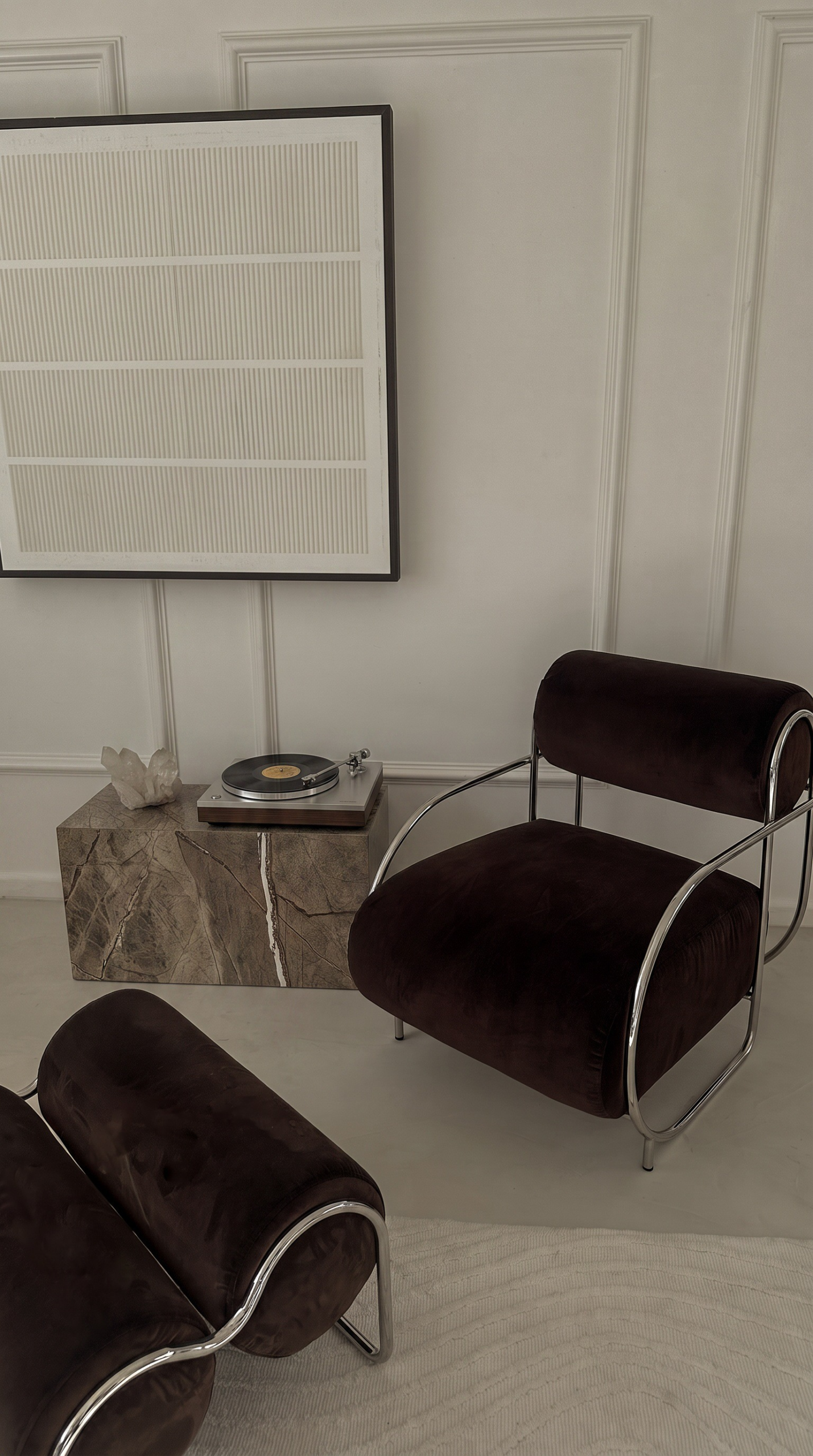 Neo Deco living room with black velvet chairs and chrome accents